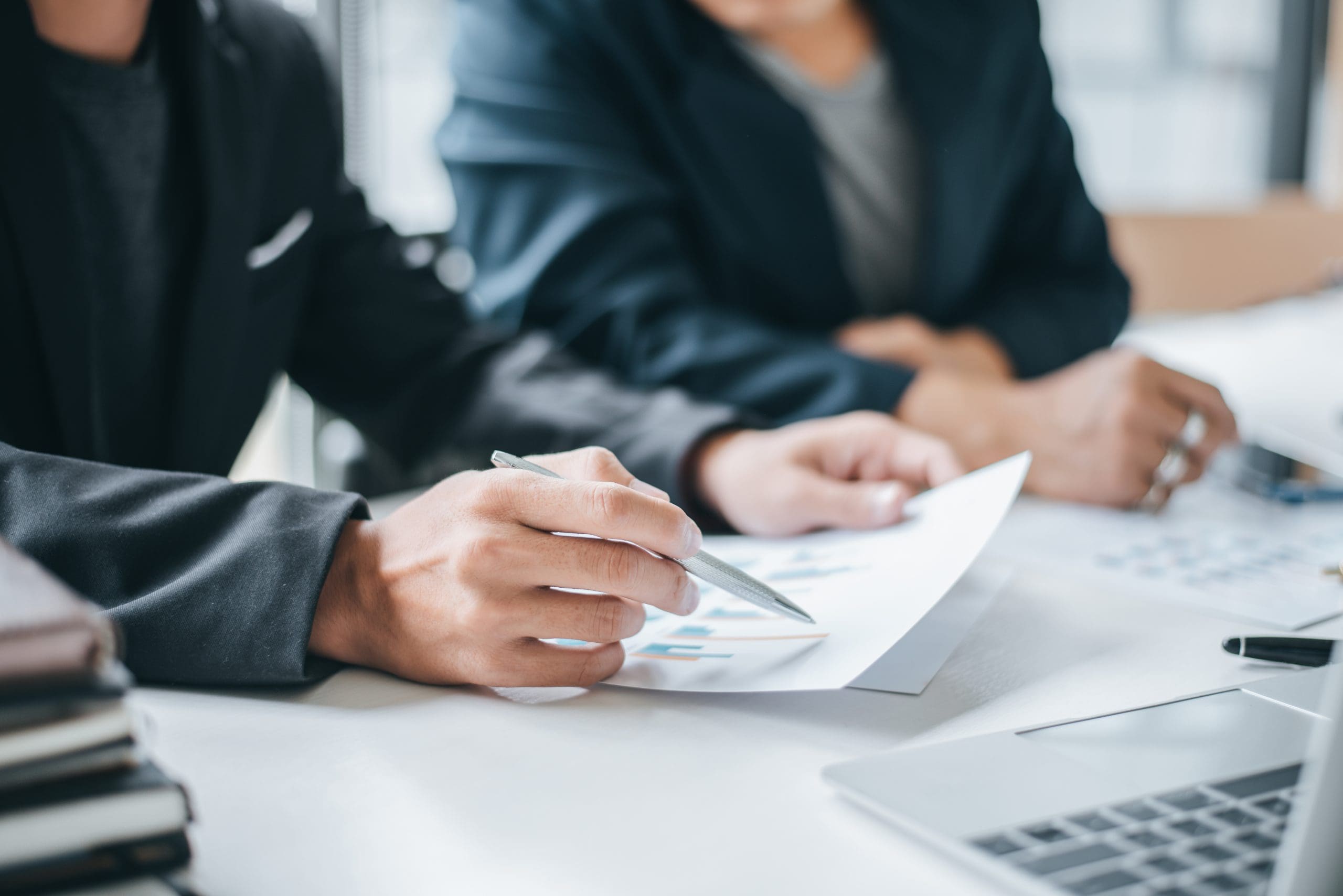 Business people discussion and summary financial information at
