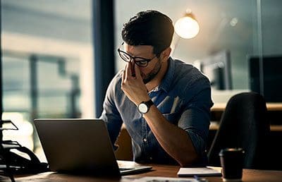 Frustrated man sitting at desk